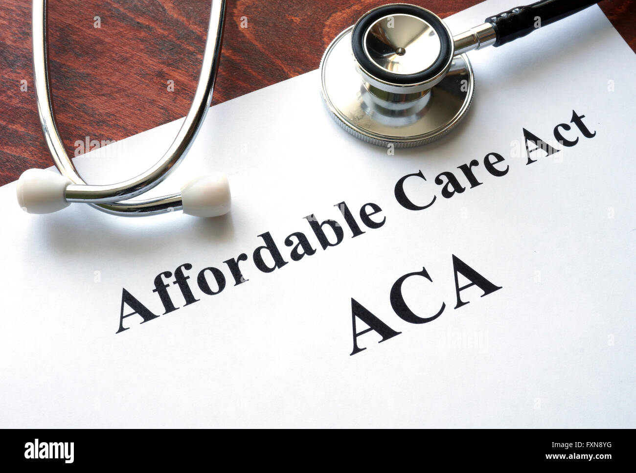 Words Affordable Care Act  ACA written on a paper. Stock Photo