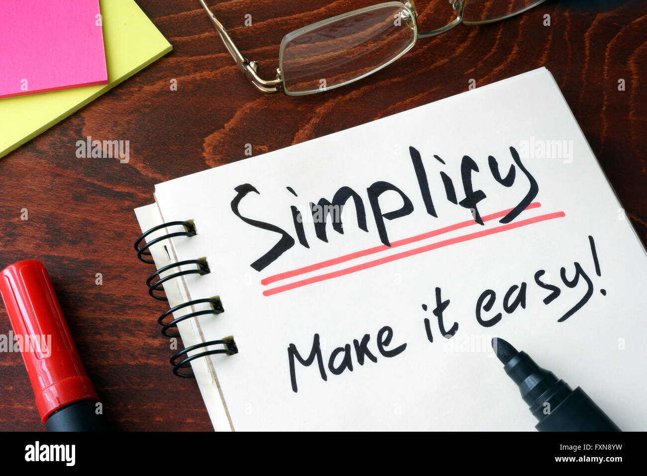Notepad with sign simplify.  Make it easy. Stock Photo