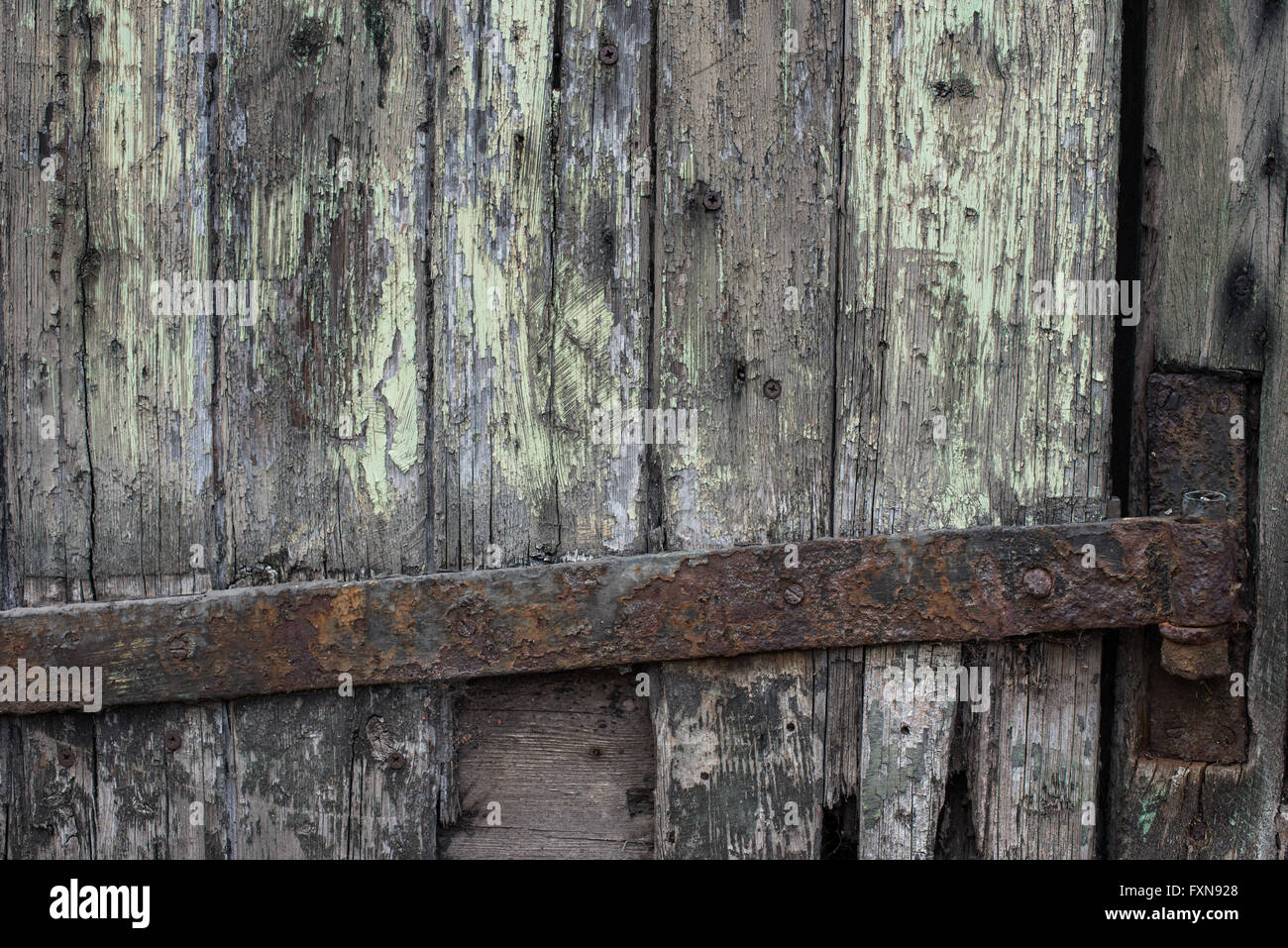 Rusty iron hinge on rotten wood Stock Photo