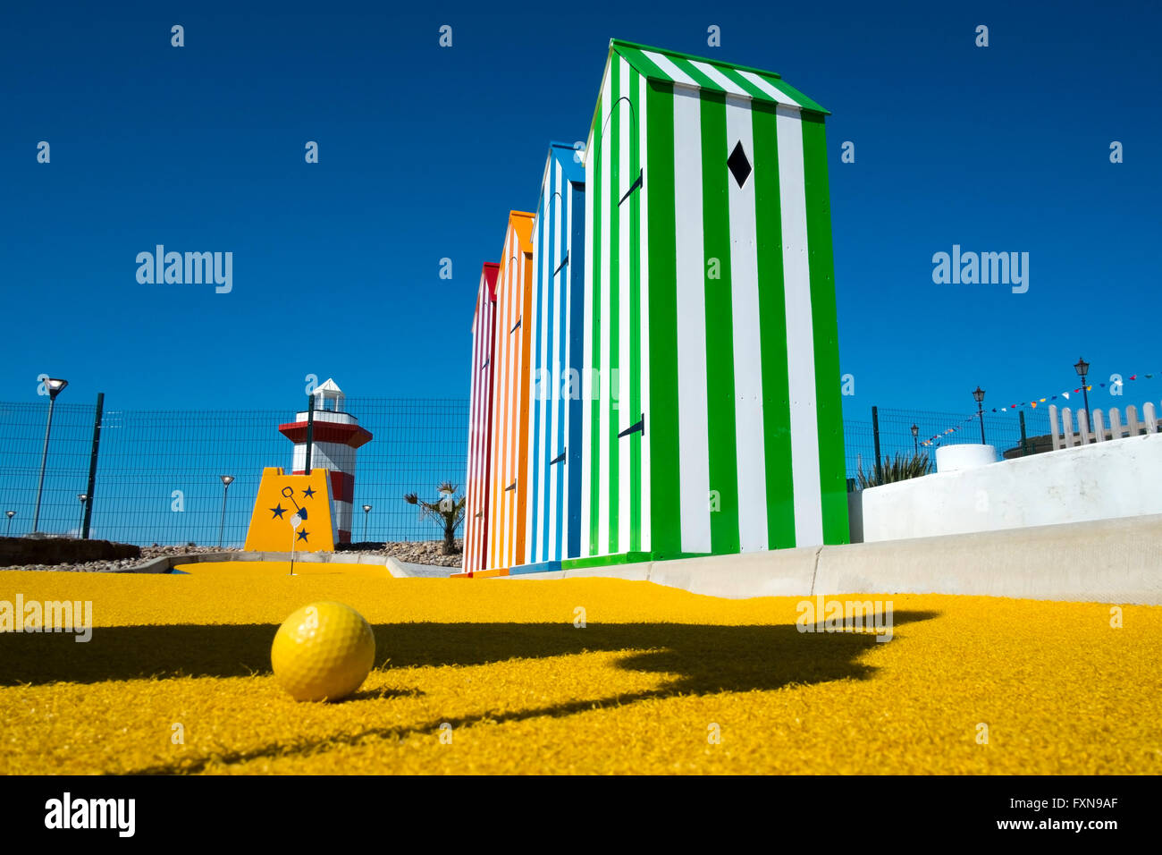 Seaside mini-golf, crazy, playing, silly, crazy, putter, action, recreation, summer, miniature golf,sport, ball, leisure, hole, club, fun course, UK Stock Photo
