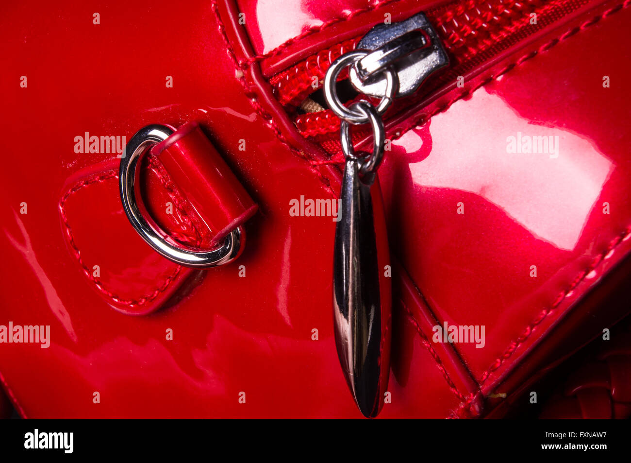 closeup of the fittings on the red lacquer hand bag Stock Photo