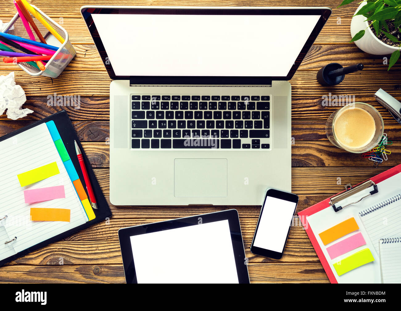 Laptop with other modern electonic devices on desk Stock Photo