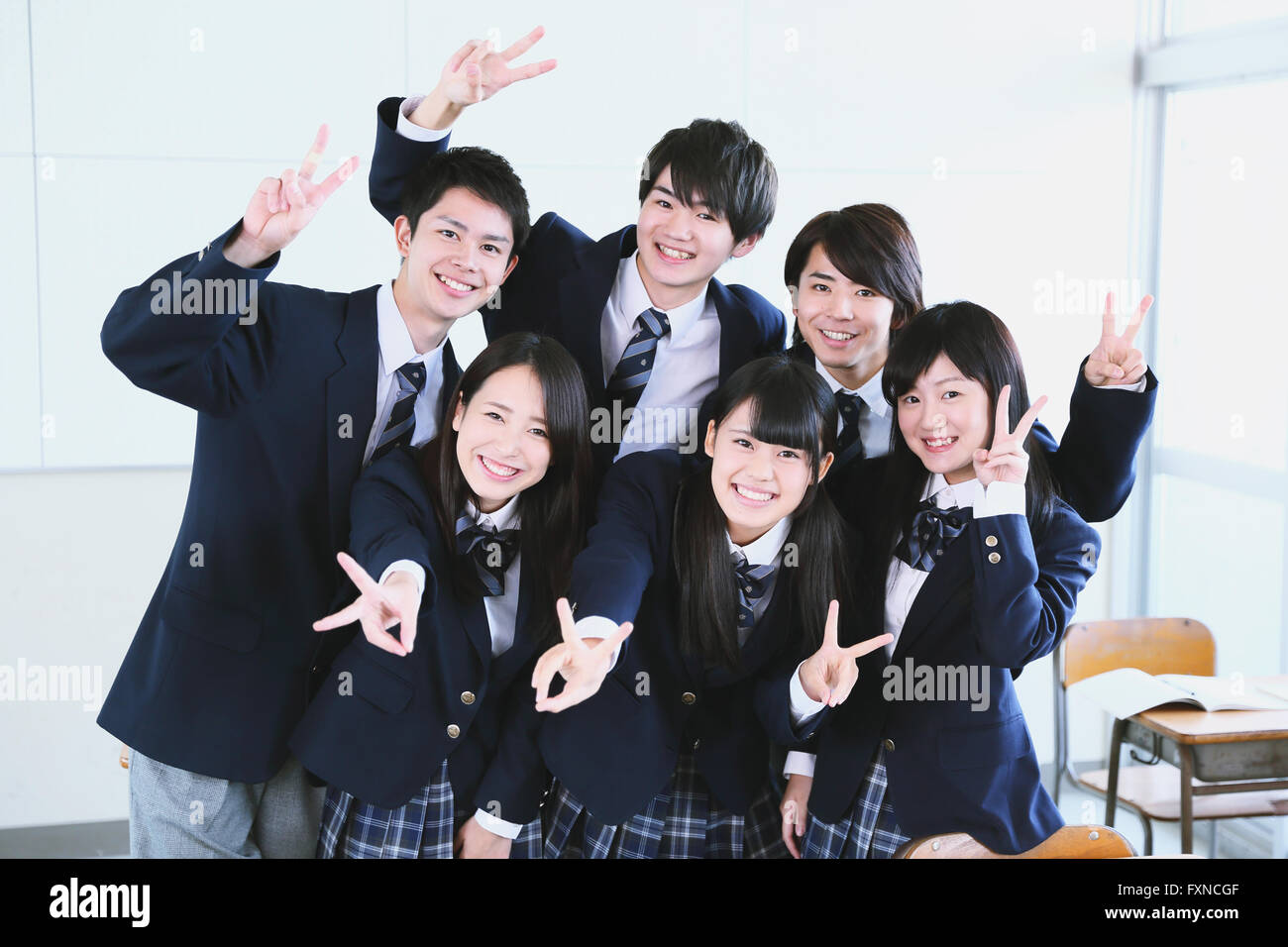 Japanese high-school student taking group shot in classroom Stock Photo