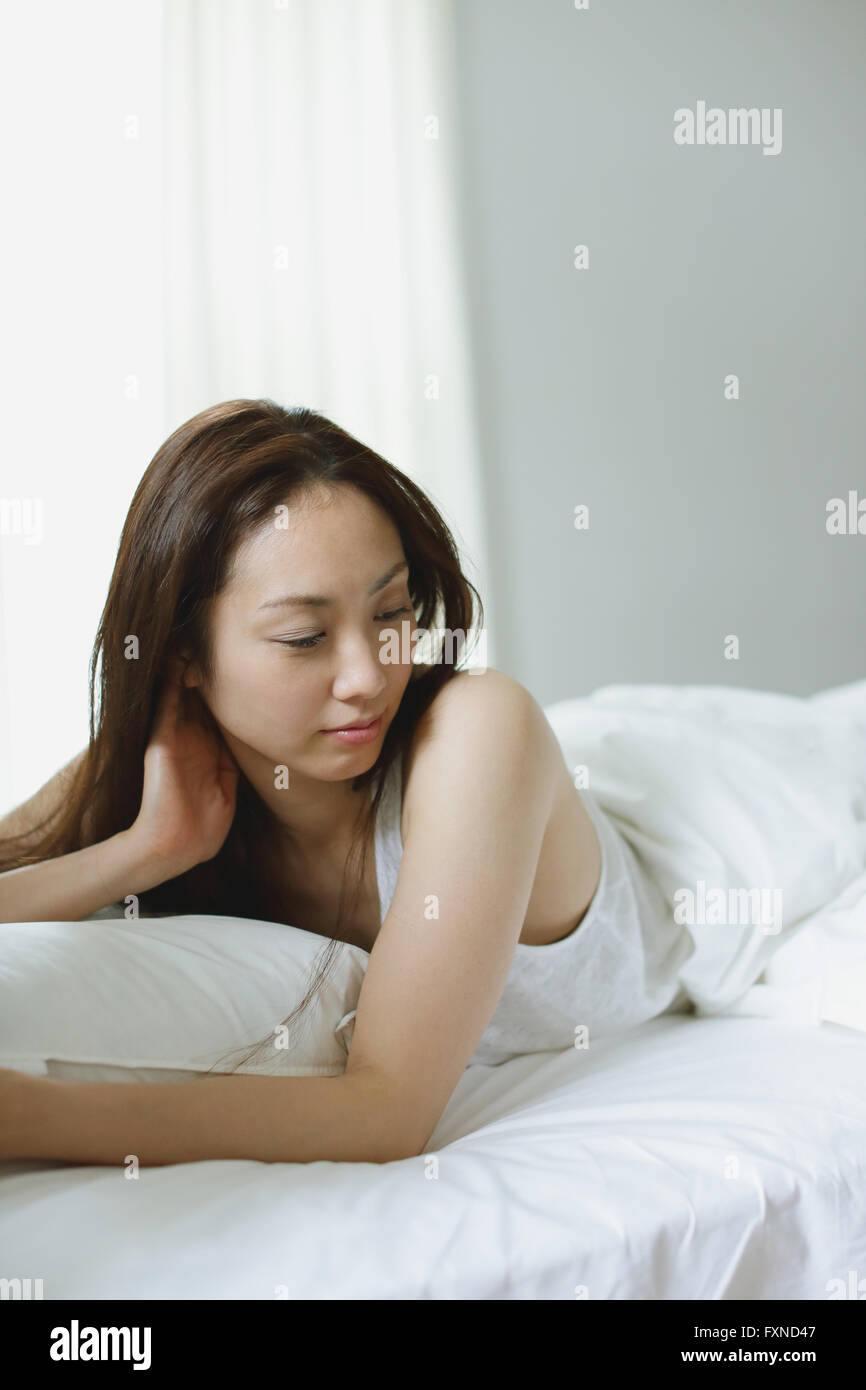 Young attractive Japanese woman in bed Stock Photo Alamy