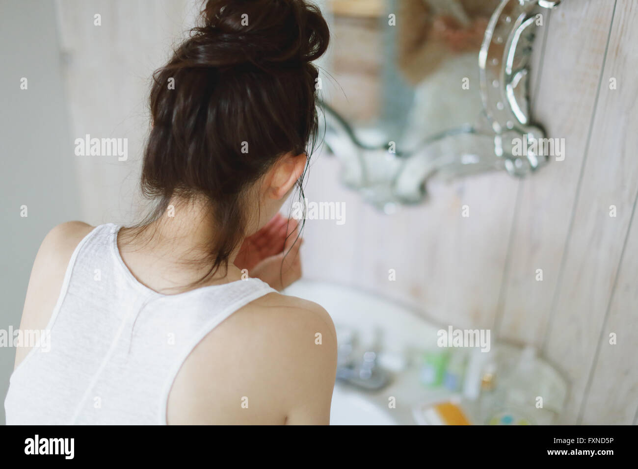 Young attractive Japanese woman washing face in the bathroom Stock ...