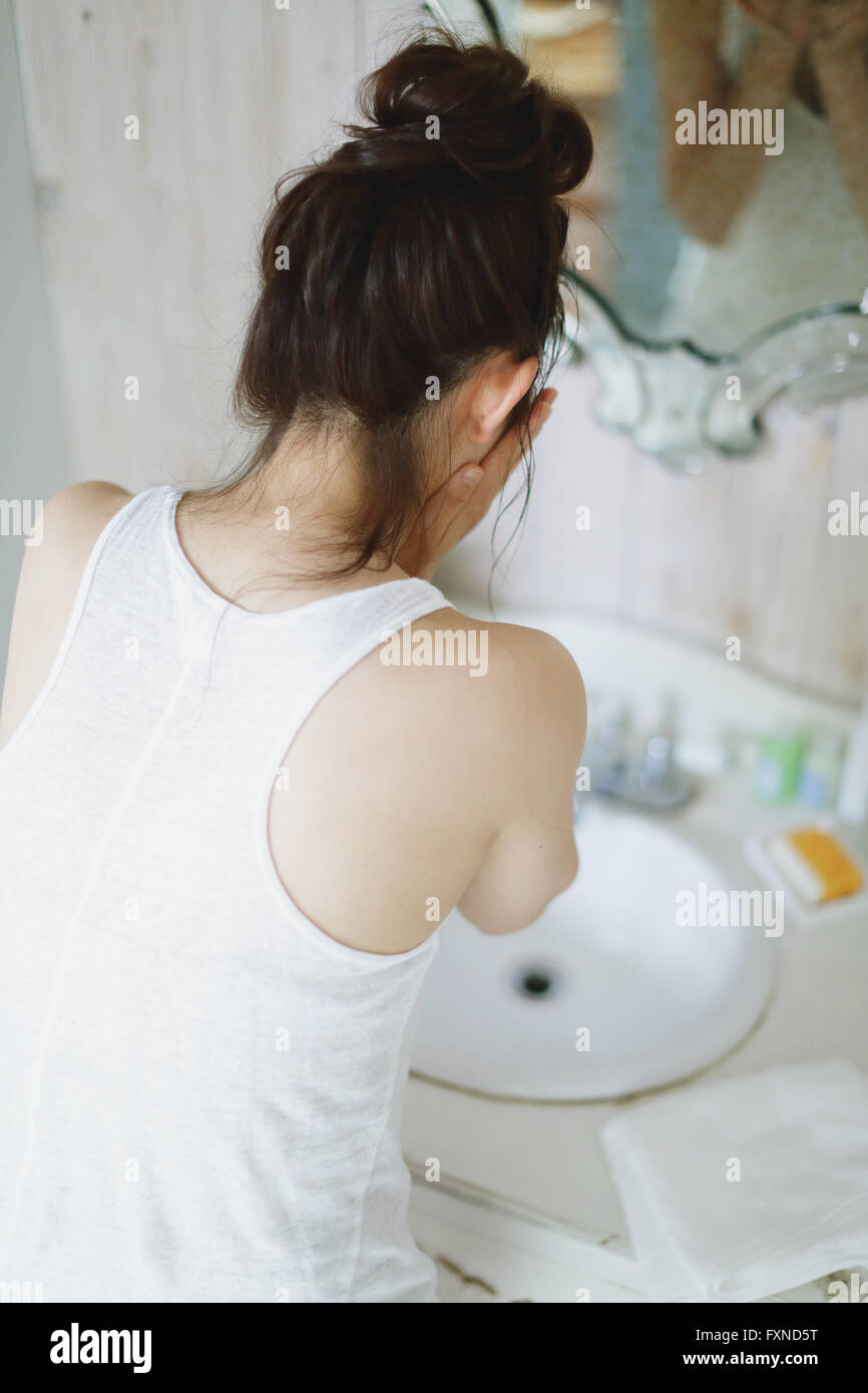 Young attractive Japanese woman washing face in the bathroom Stock ...