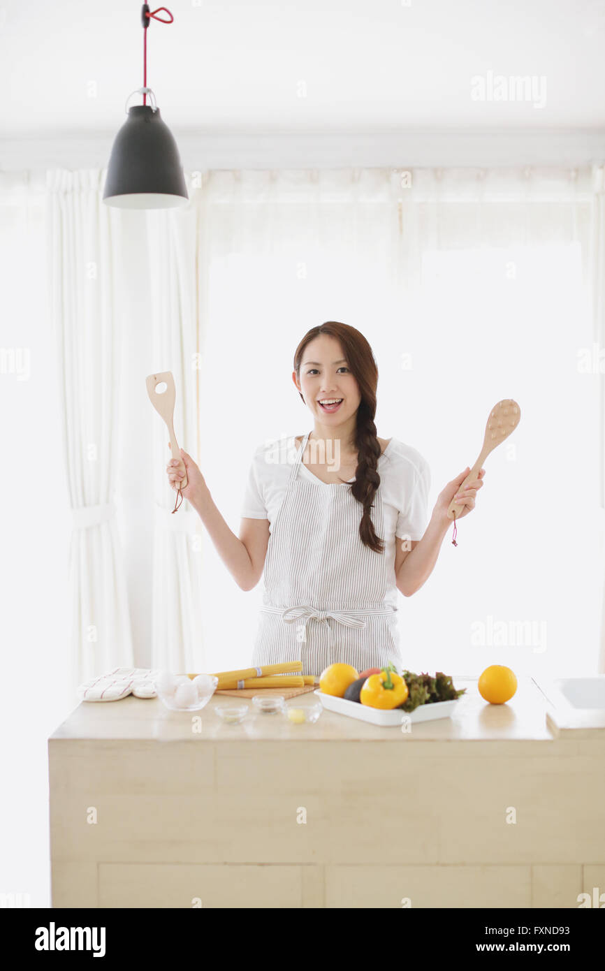Young attractive Japanese woman cooking at home Stock Photo Alamy