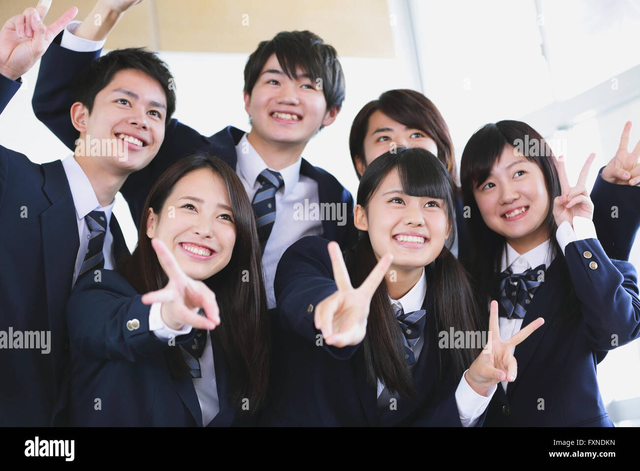 Japanese high-school student taking group shot in classroom Stock Photo