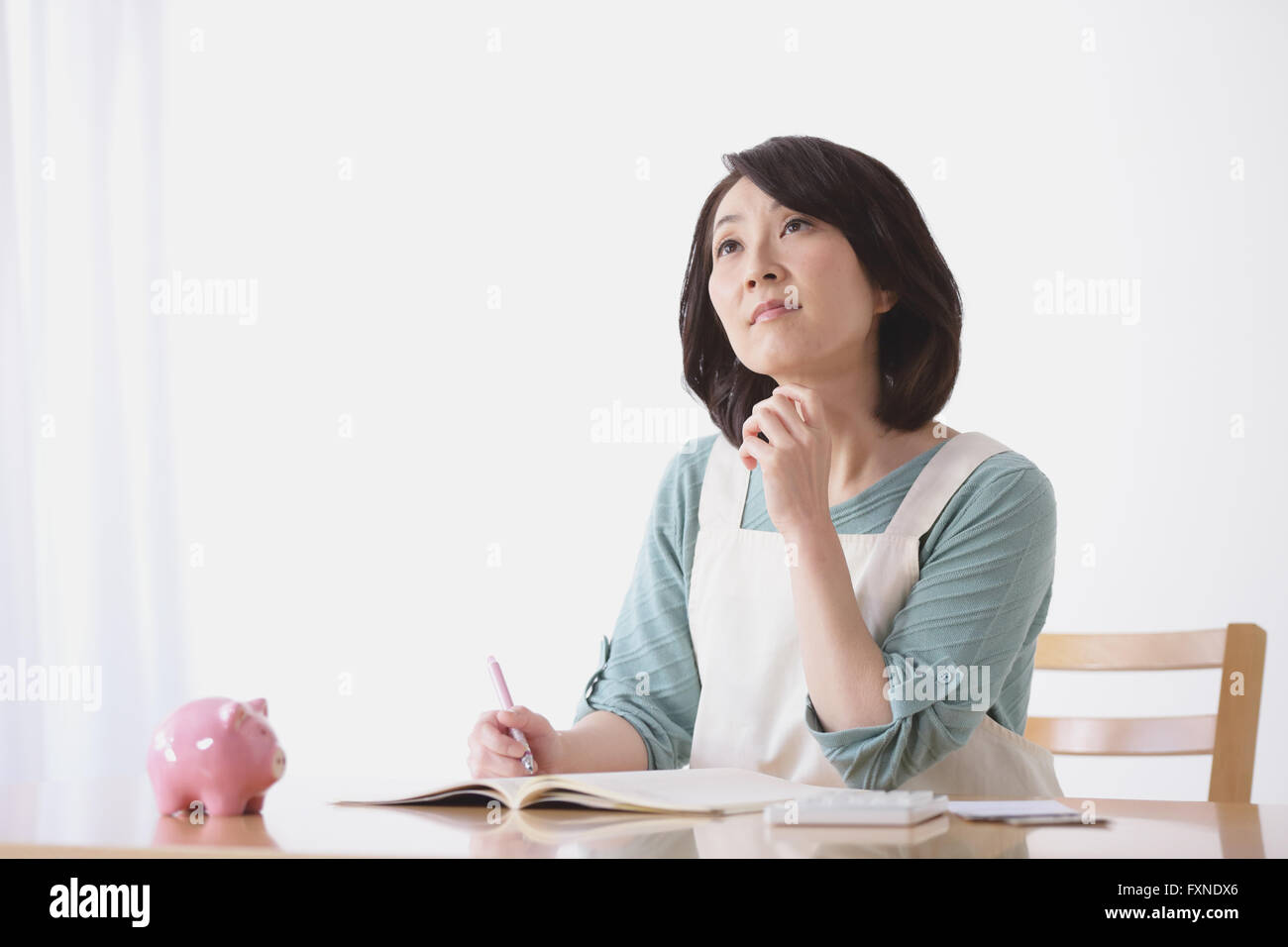Senior Japanese woman doing accounting in the living room Stock Photo Alamy