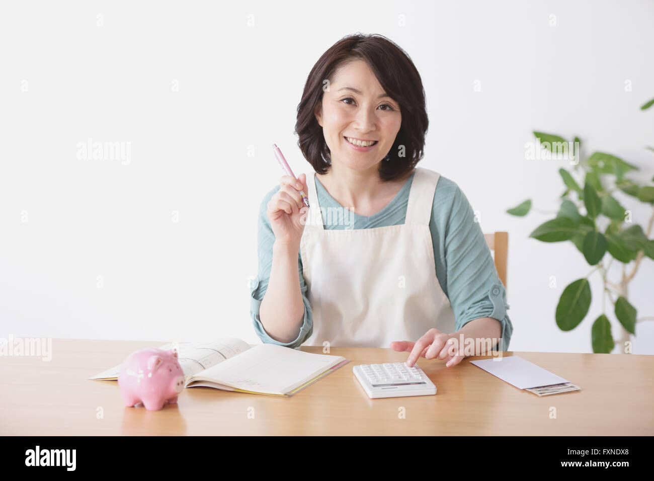 Senior Japanese woman doing accounting in the living room Stock Photo Alamy