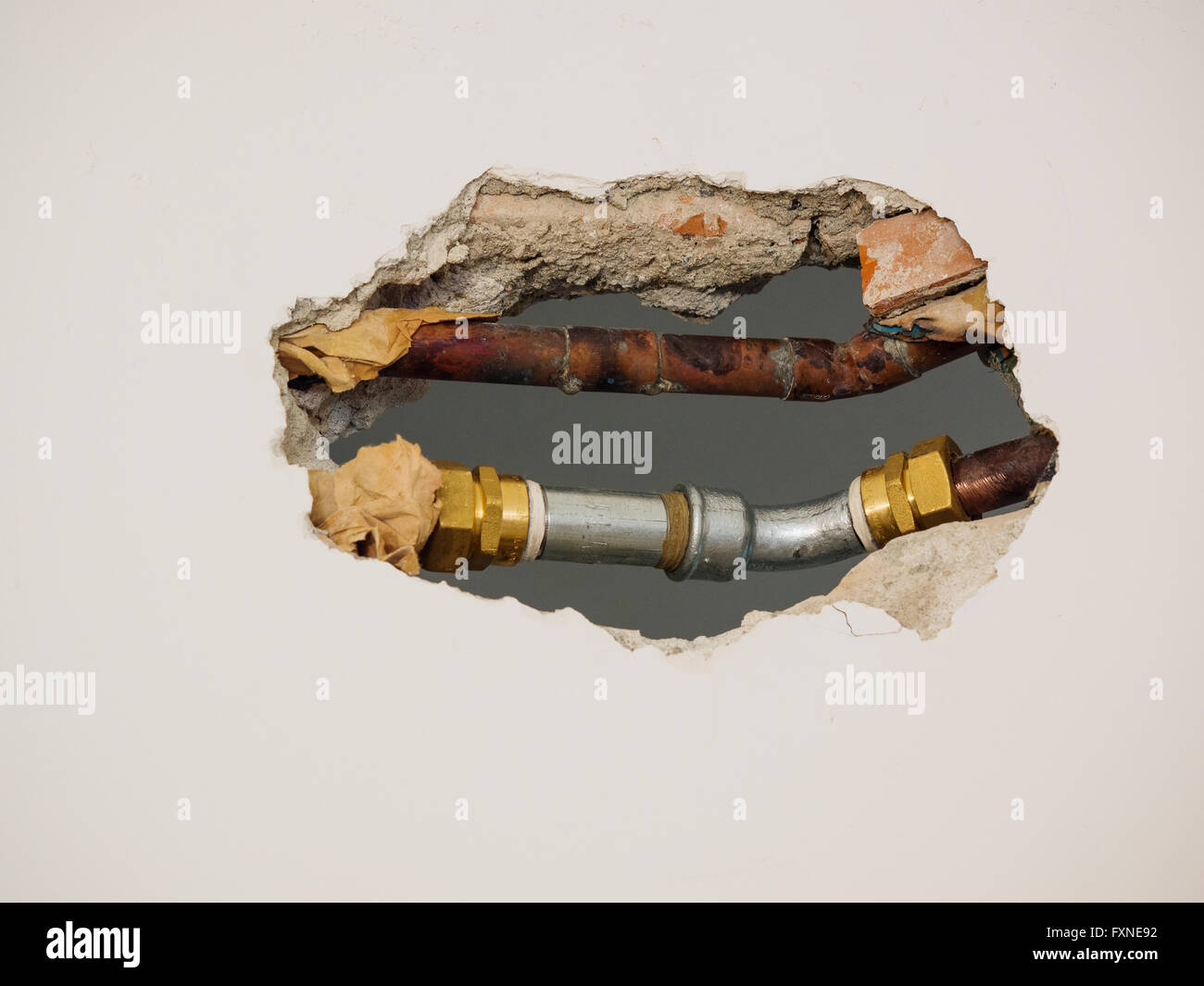 metal pipes and fittings of domestic water supply system seen through a