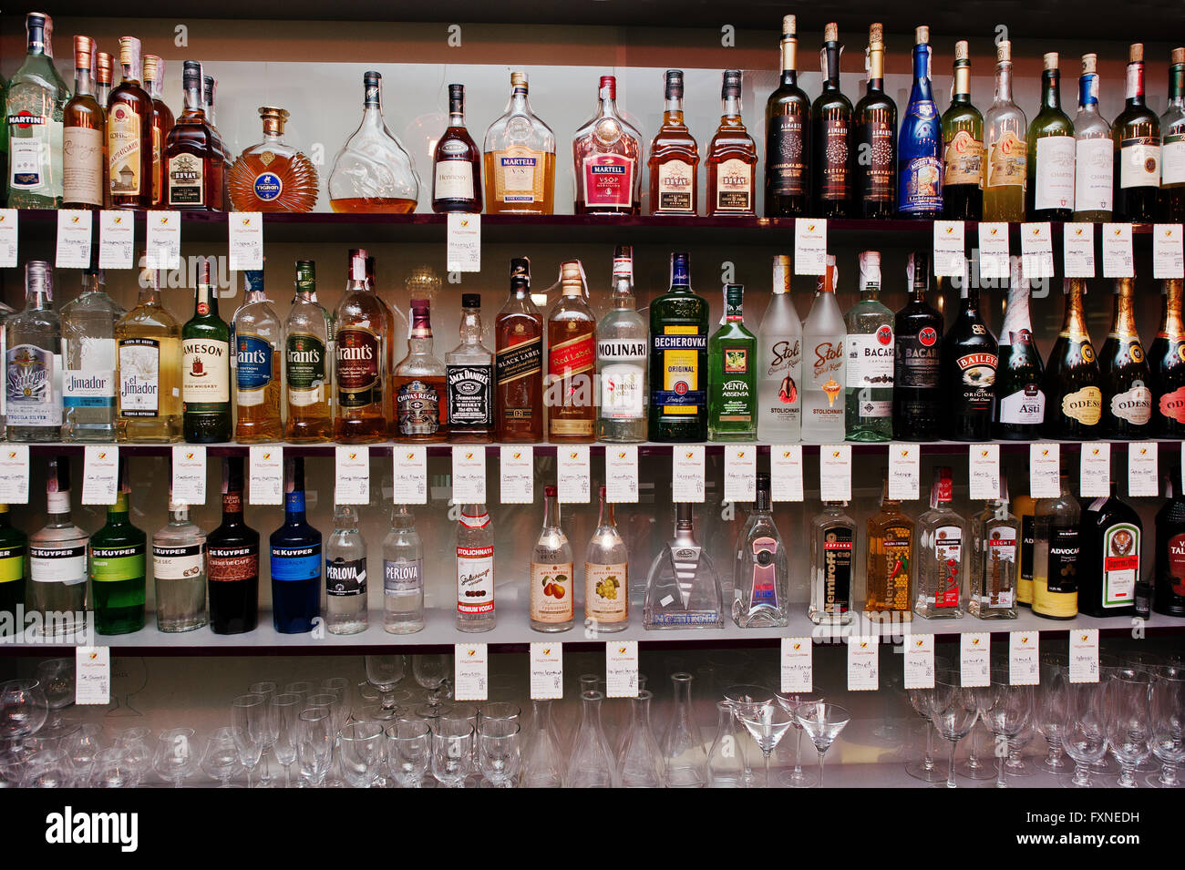 KYIV, UKRAINE - MARCH 25, 2016: Various alcoholic beverages bottles in the bar on the shelf. Stock Photo