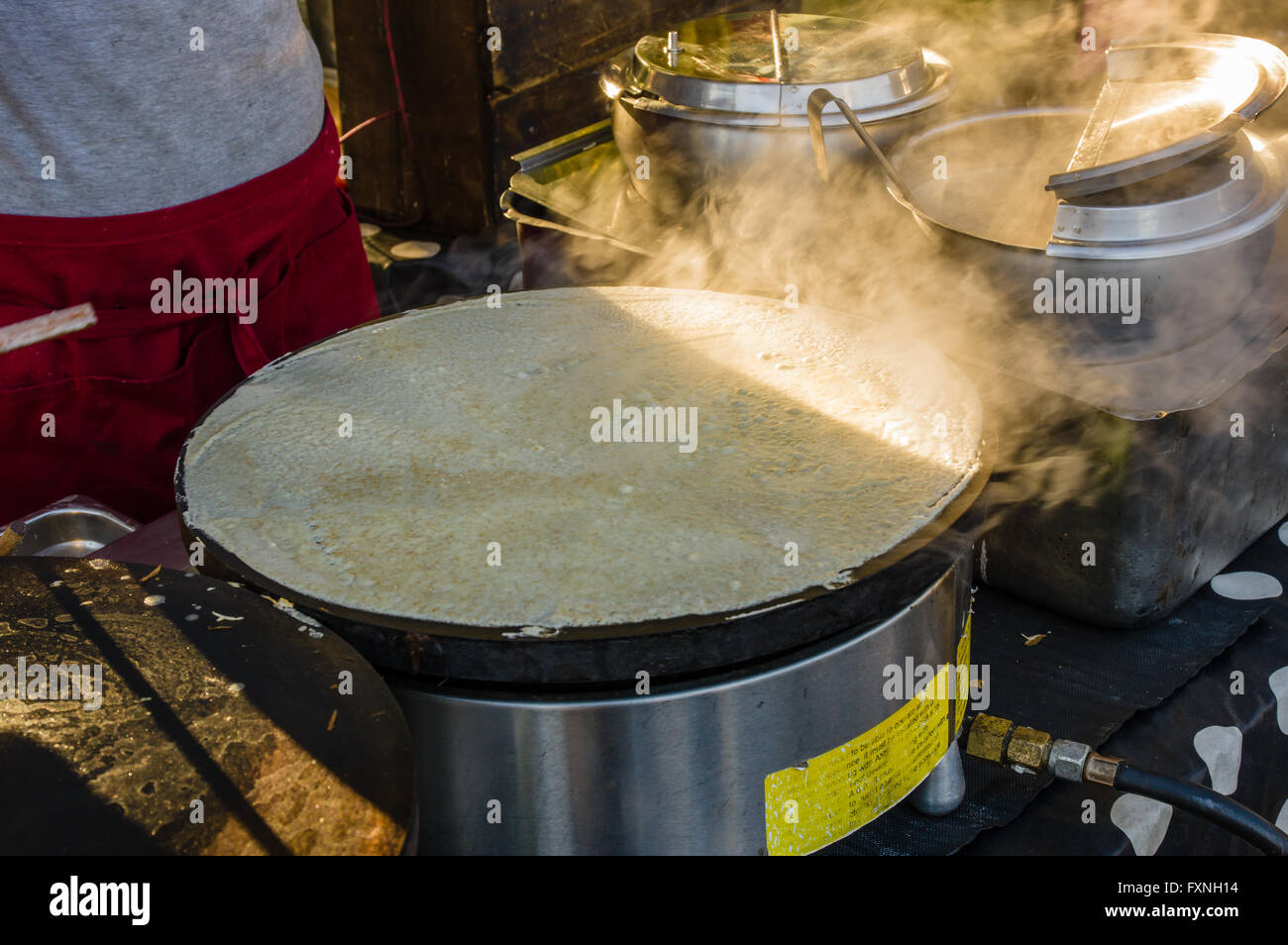 Crepe cooker with bubbling crepes at a market stall.  Beaverton, Oregon Stock Photo