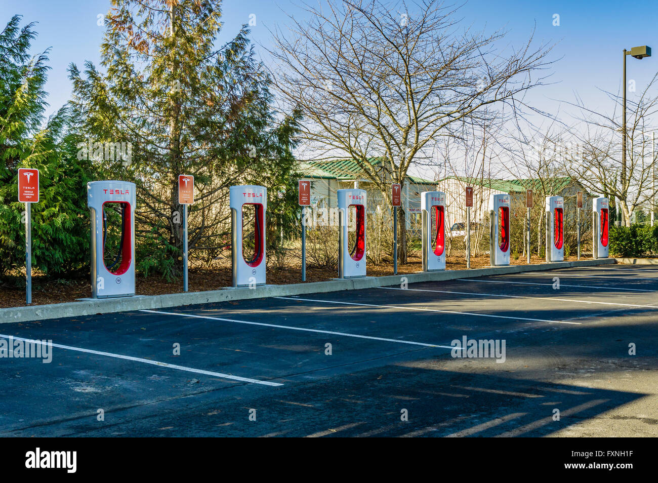 Tesla electric vehicle charging stations at a grocery store. Sandy