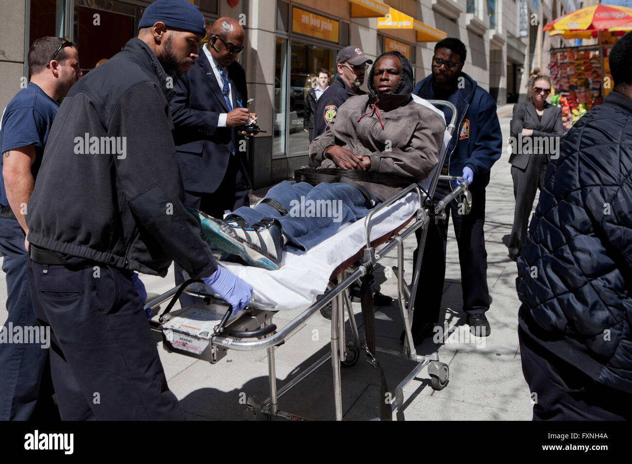 DC Fire & EMT team respond to a person in distress on sidewalk - Washington, DC USA Stock Photo