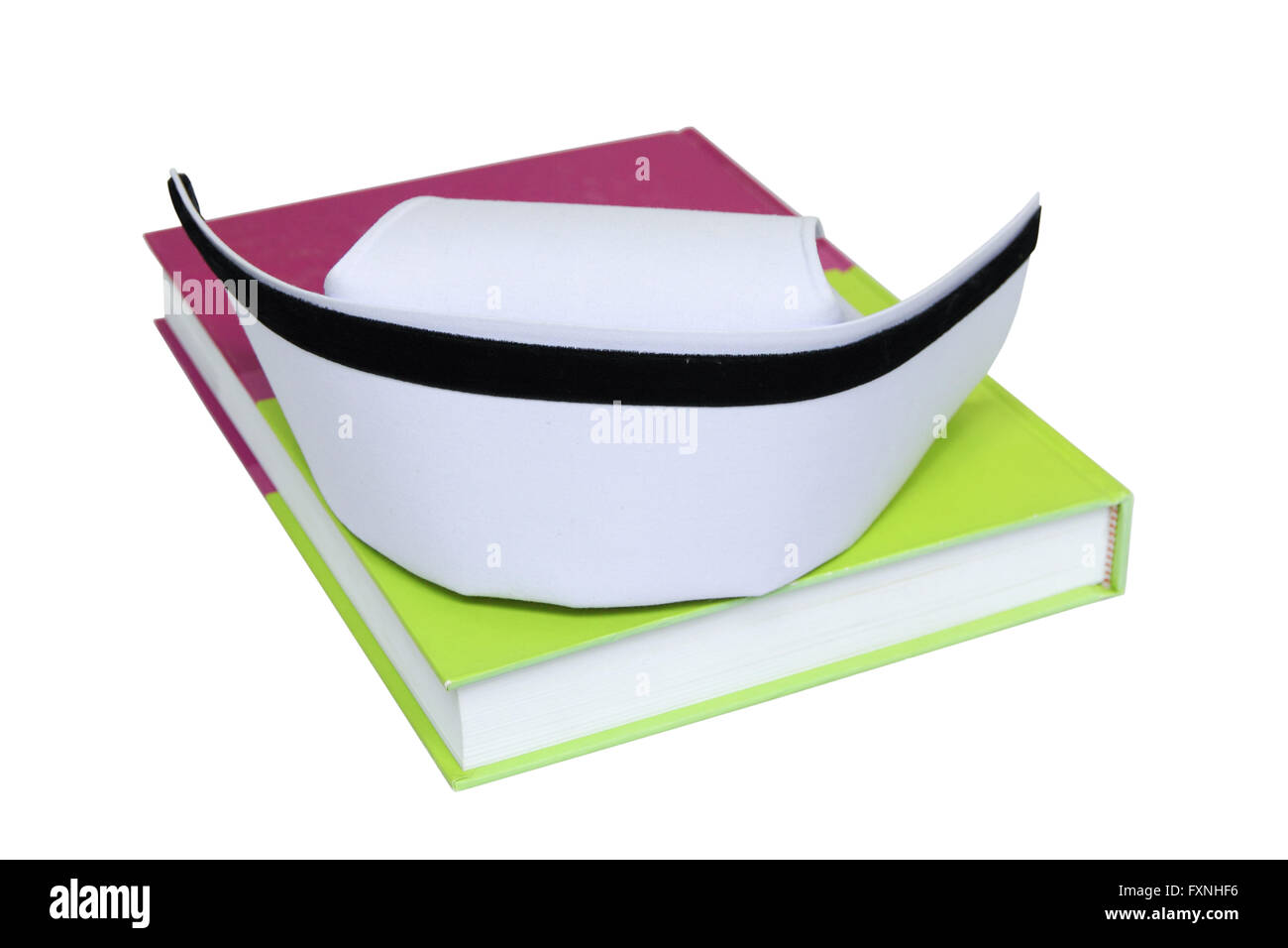 An isolated nurse hat on textbook and isolated white background with paths Stock Photo