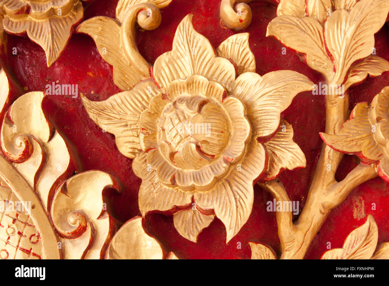 Art of wood carving. Cotton rose (Hibiscus mutabilis L) in line thai art.  A beautiful Asian sculptures. Stock Photo