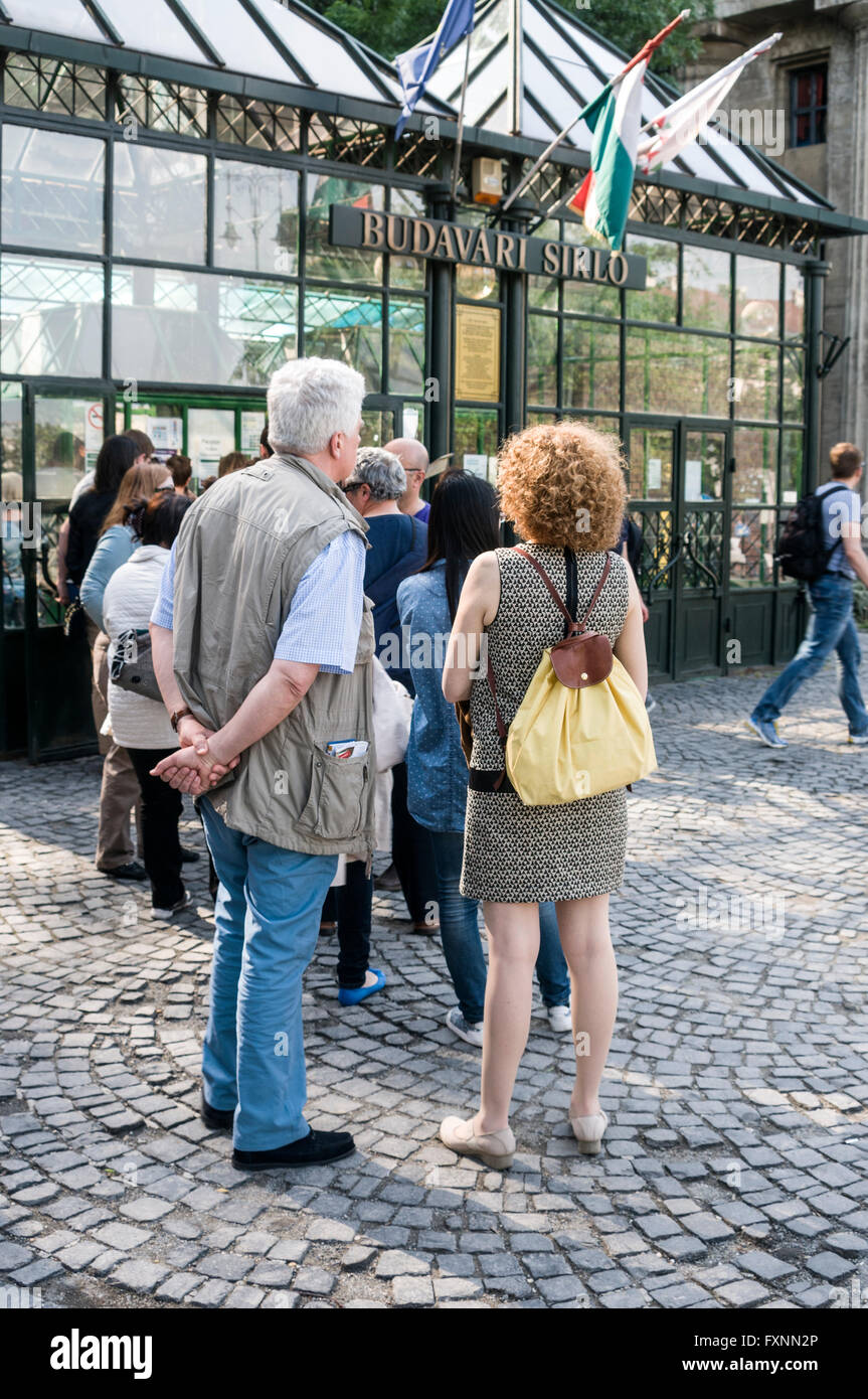 A line of tourists queue at the funicular terminal at the foot of Castle Hill on the Buda side of Budapest in Hungary. Stock Photo