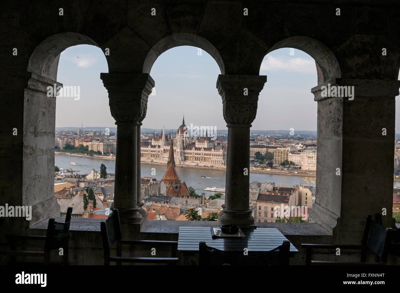 View of the Hungarian Parliament across the River Danube from a restaurant in the Fishermen's Bastion at Buda Castle hill in Bud Stock Photo