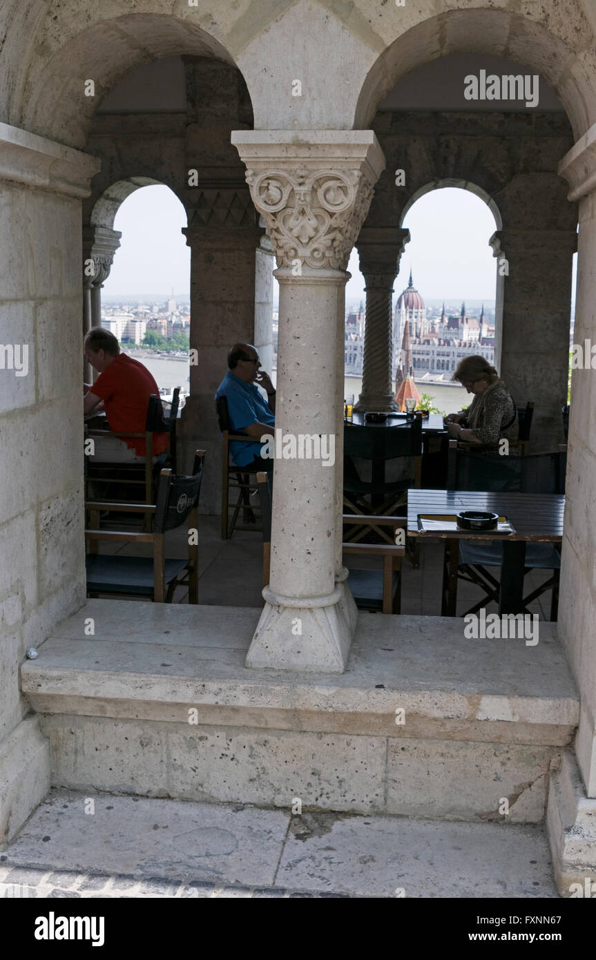 Diners at a restaurant have a clear view of the Pest side and the River Danube  from Fishermen's Bastion on Buda Castle Hill in Stock Photo