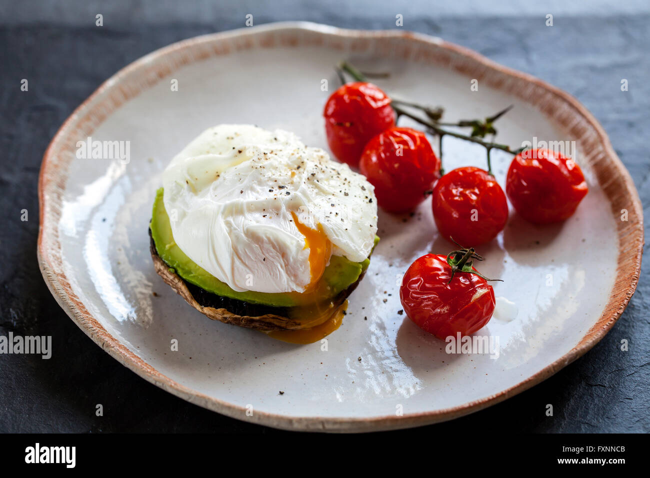 Breakfast, mushrooms with avocado and poached eggs and roast cherry