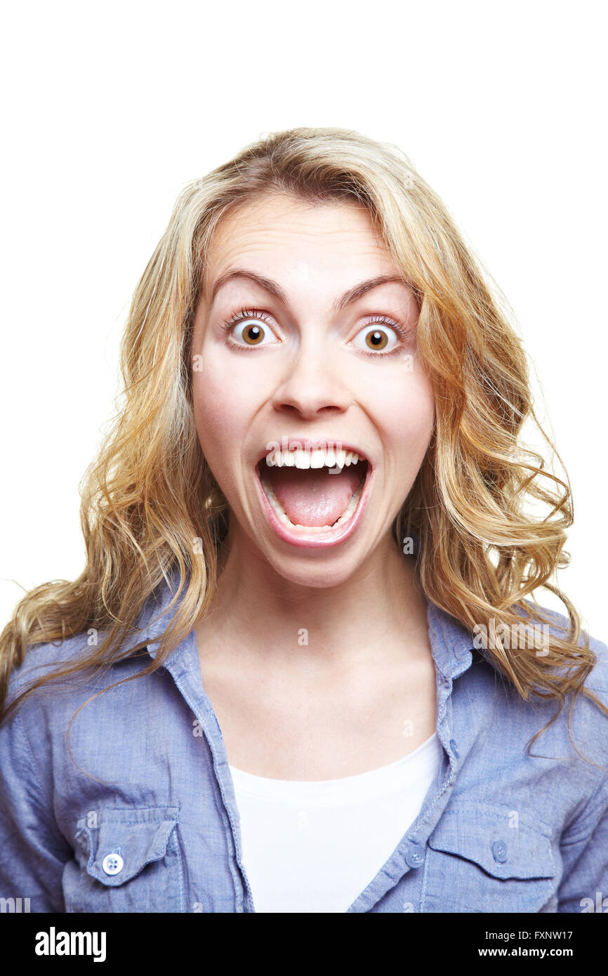 Young blonde woman with curly hair screaming with mouth wide open Stock Photo