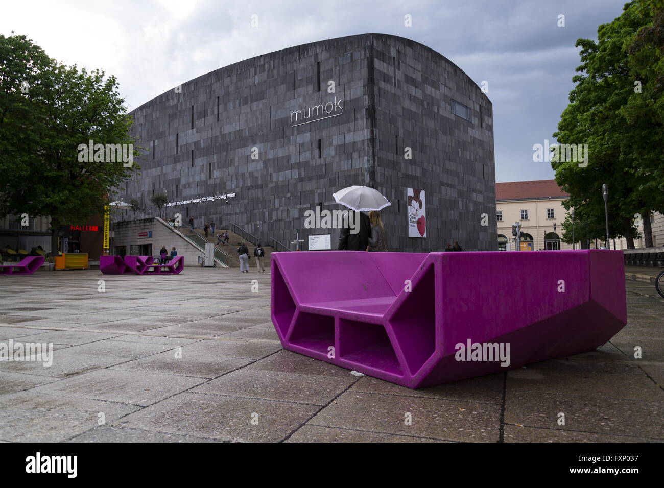 VIENNA, AUSTRIA - MAY 6: People rest on red benches in front of the MUMOK, Museum of modern art  at the MuseumsQuartier on 6 May Stock Photo