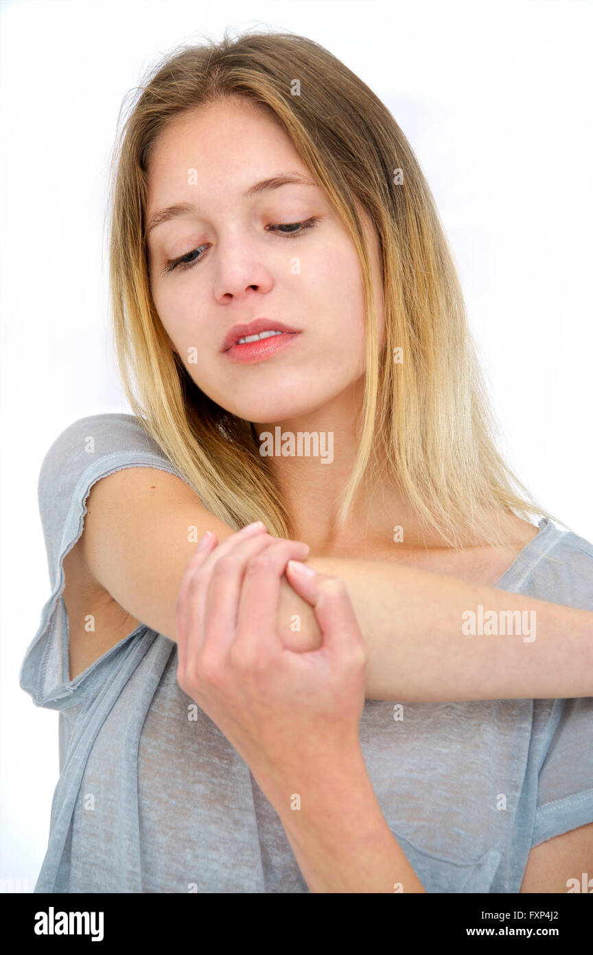 MODEL RELEASED. Young woman touching her elbow Stock Photo Alamy