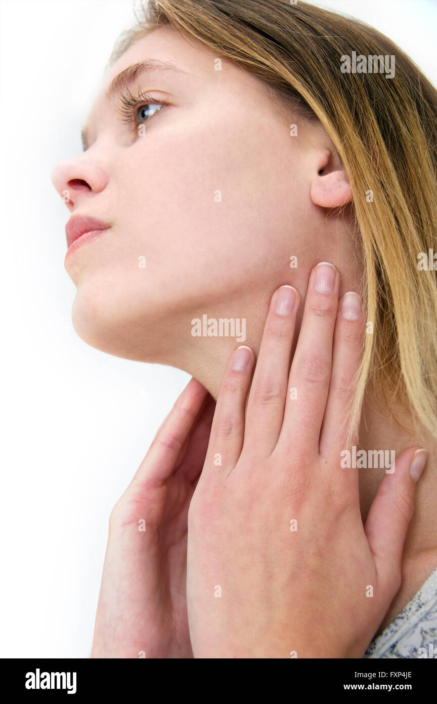 MODEL RELEASED. Young woman touching her neck. Stock Photo