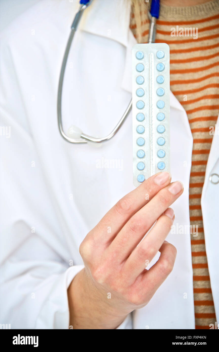 MODEL RELEASED. Doctor holding oral contraception pills, close up. Stock Photo