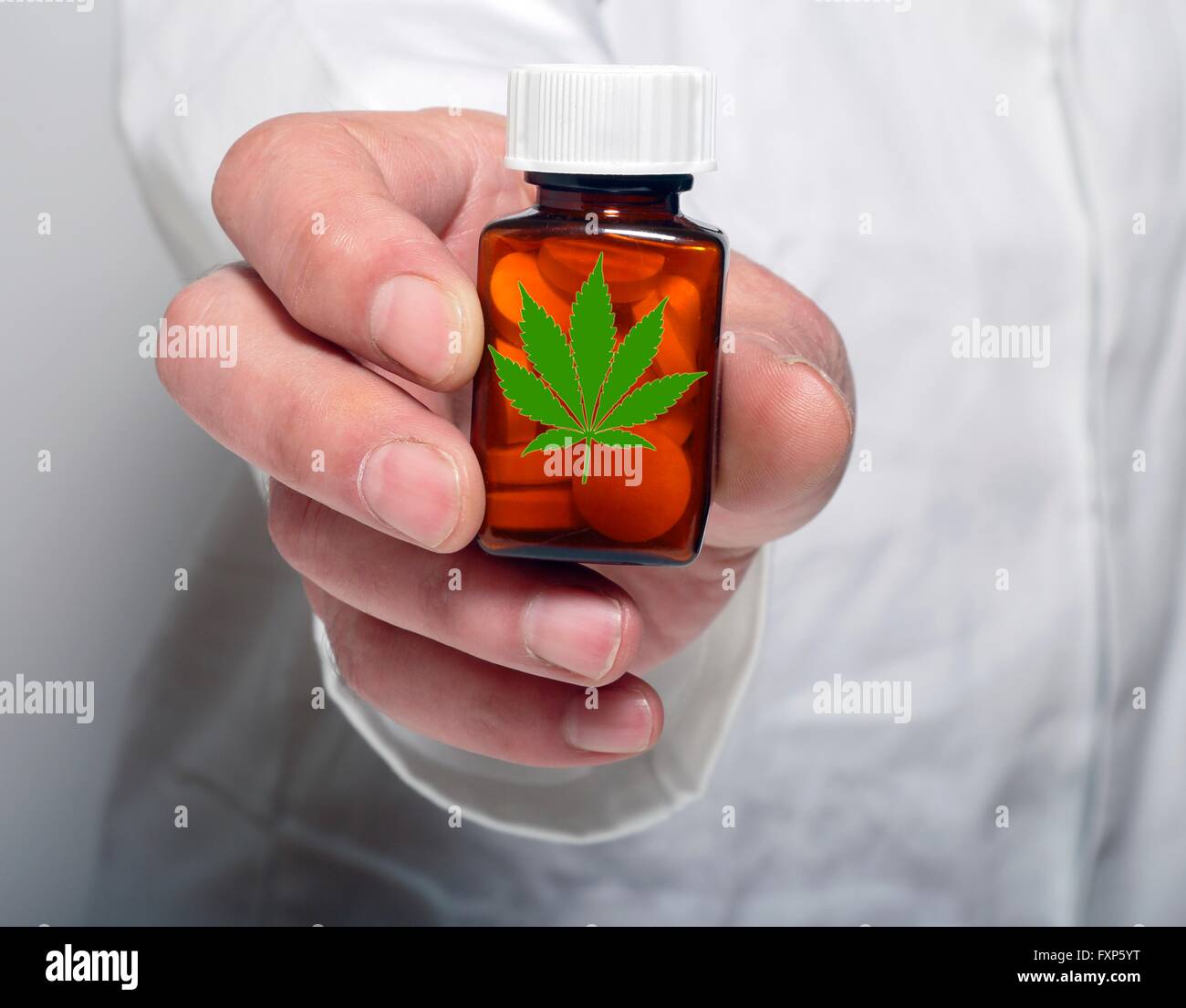 Person holding pill bottle containing medicinal marijuana Stock Photo