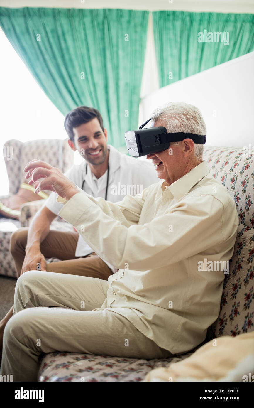 Senior man using an oculus rift in a retirement home Stock Photo