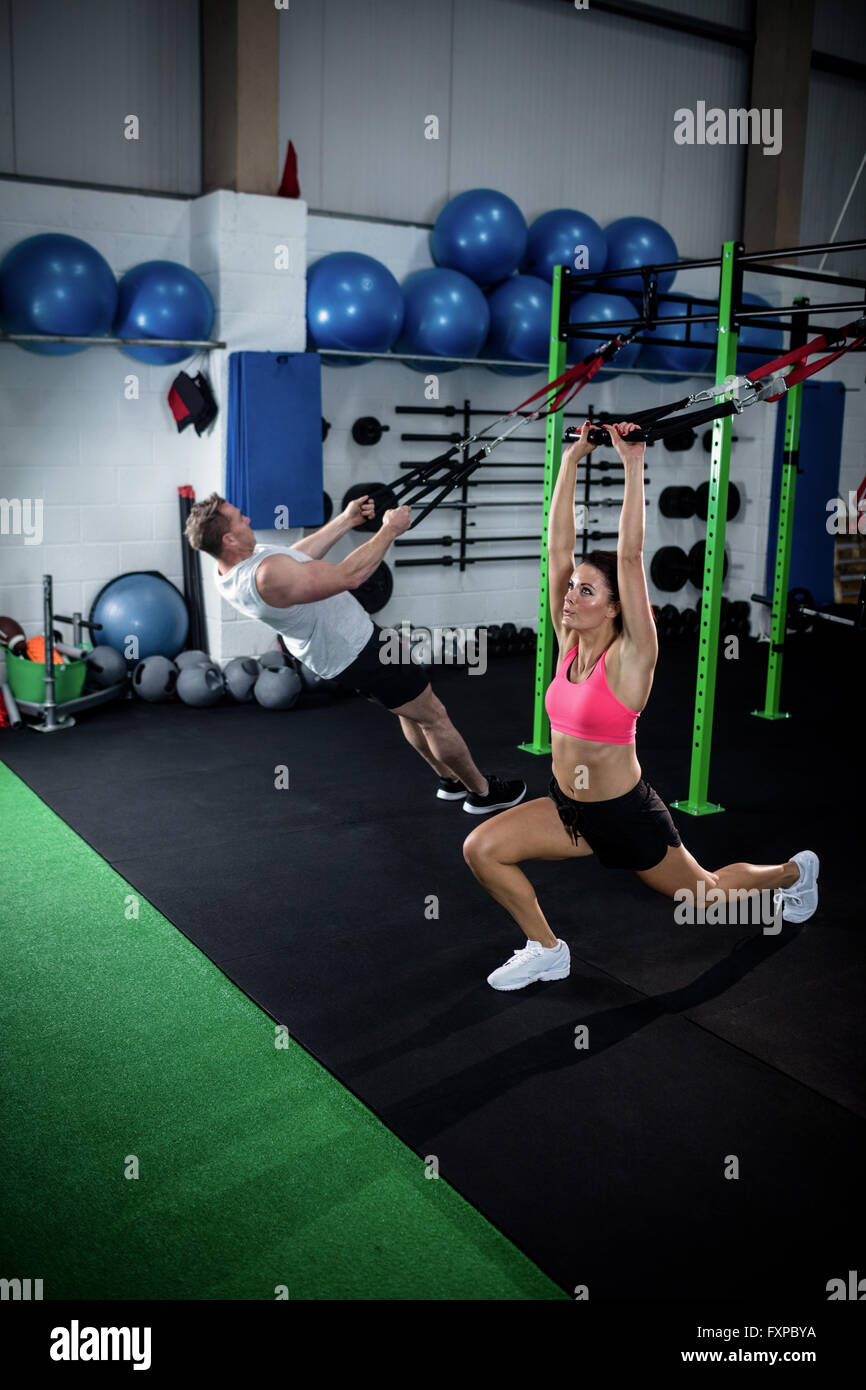 Man and woman doing suspension training with trx fitness straps Stock ...