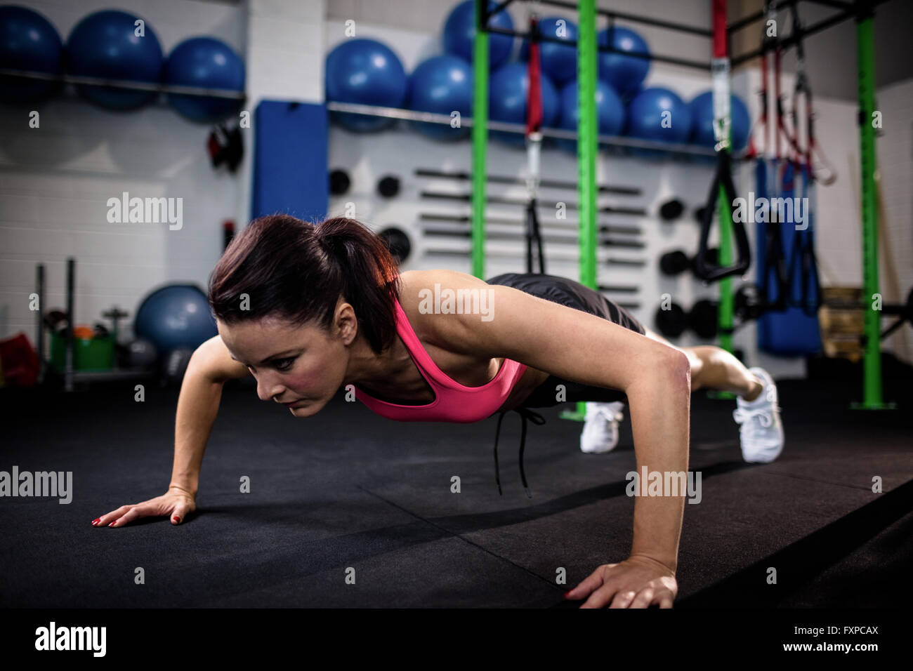Determined woman doing push ups Stock Photo