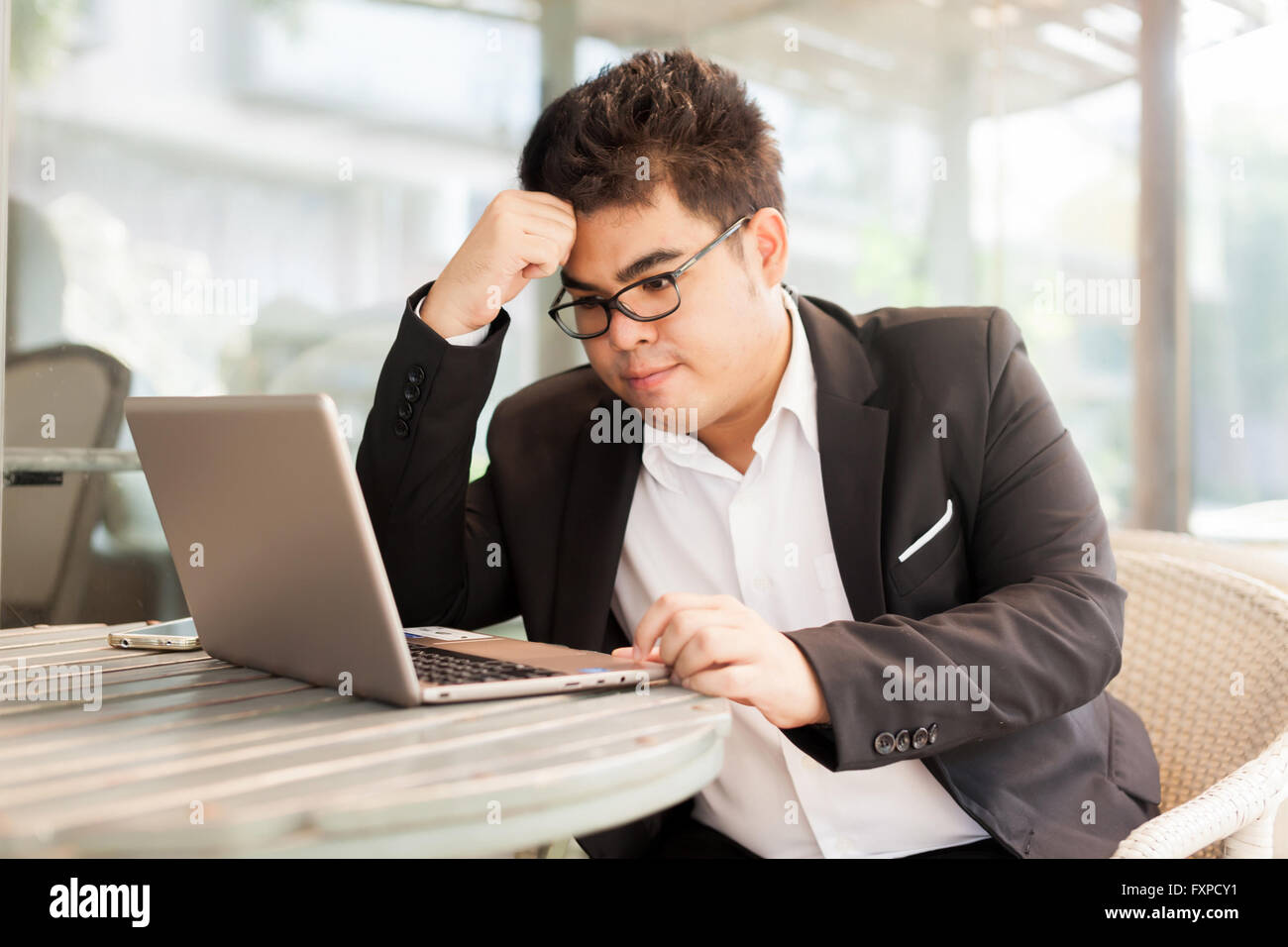 Young Asian businessman facing a problem and thinking of solution Stock ...