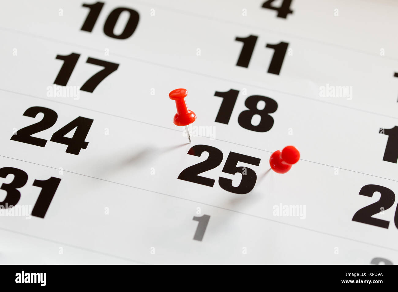 Pin pushed on a calendar concept for an important day Stock Photo - Alamy