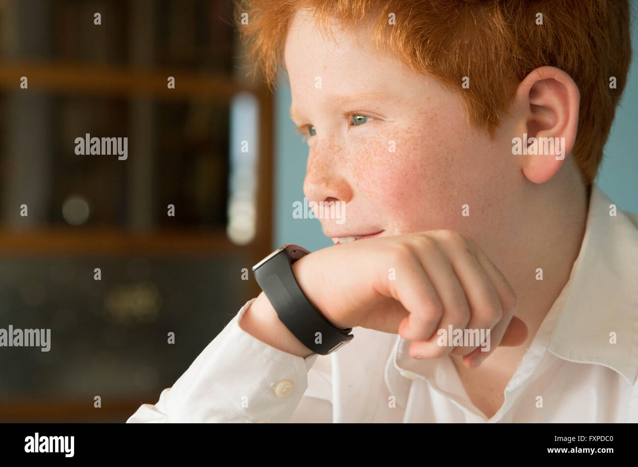 Boy speaking into smartwatch Stock Photo