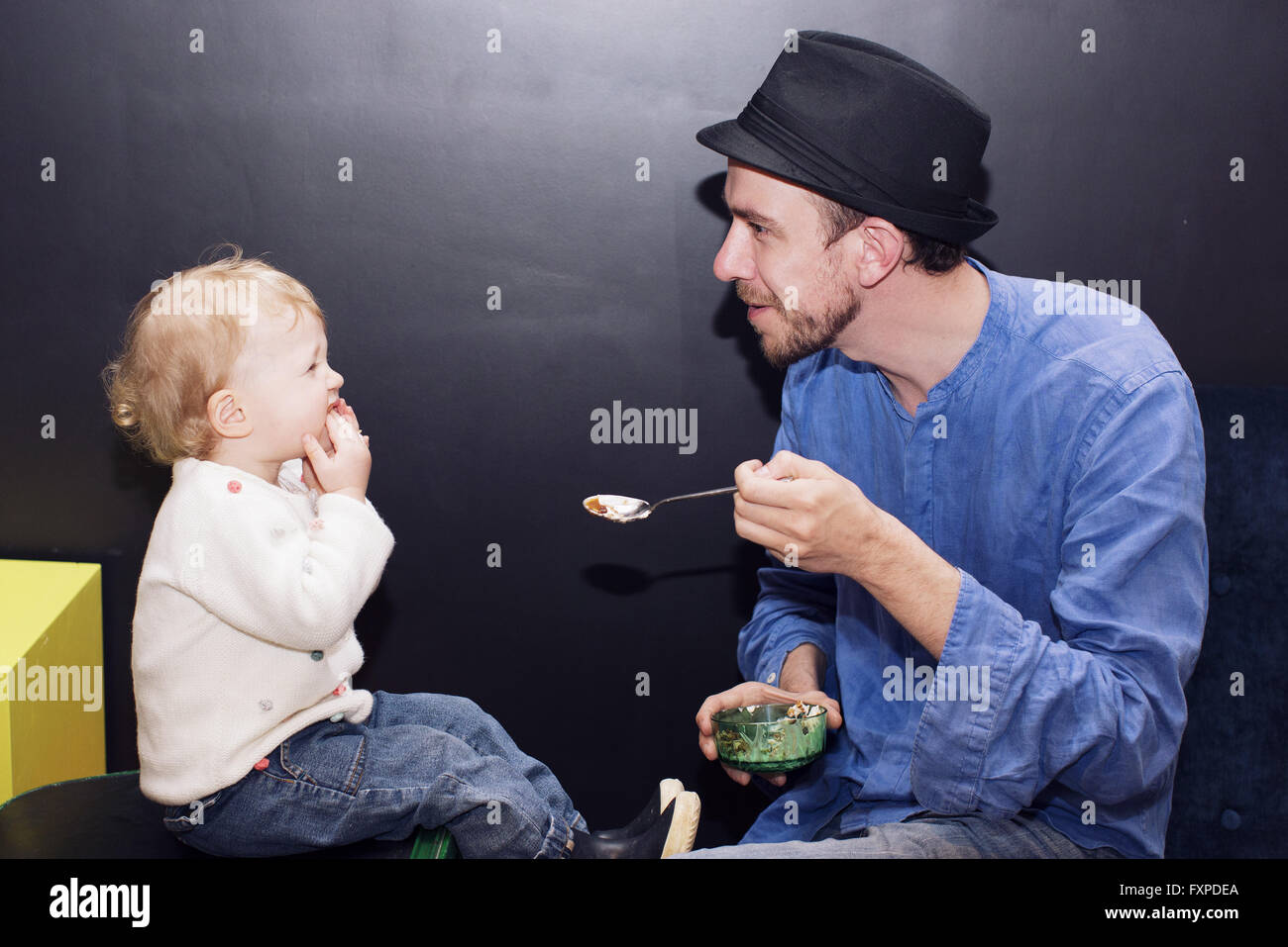 Father feeding toddler Stock Photo