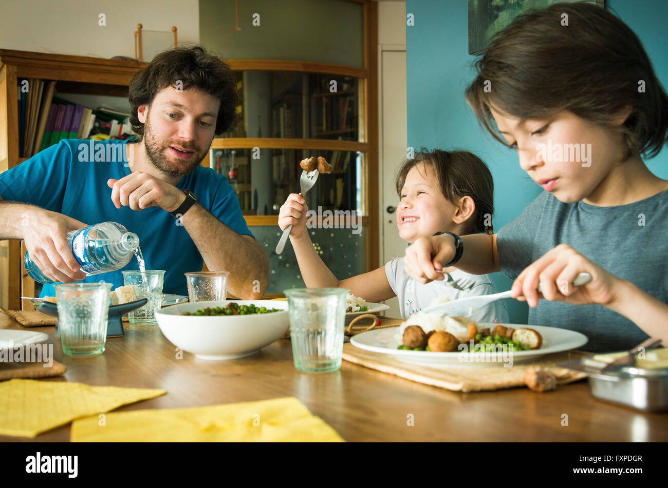Family eating dinner together Stock Photo