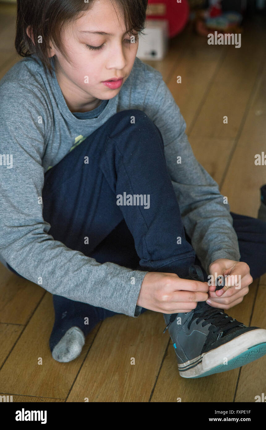 Boy tying shoe hi-res stock photography and images - Alamy