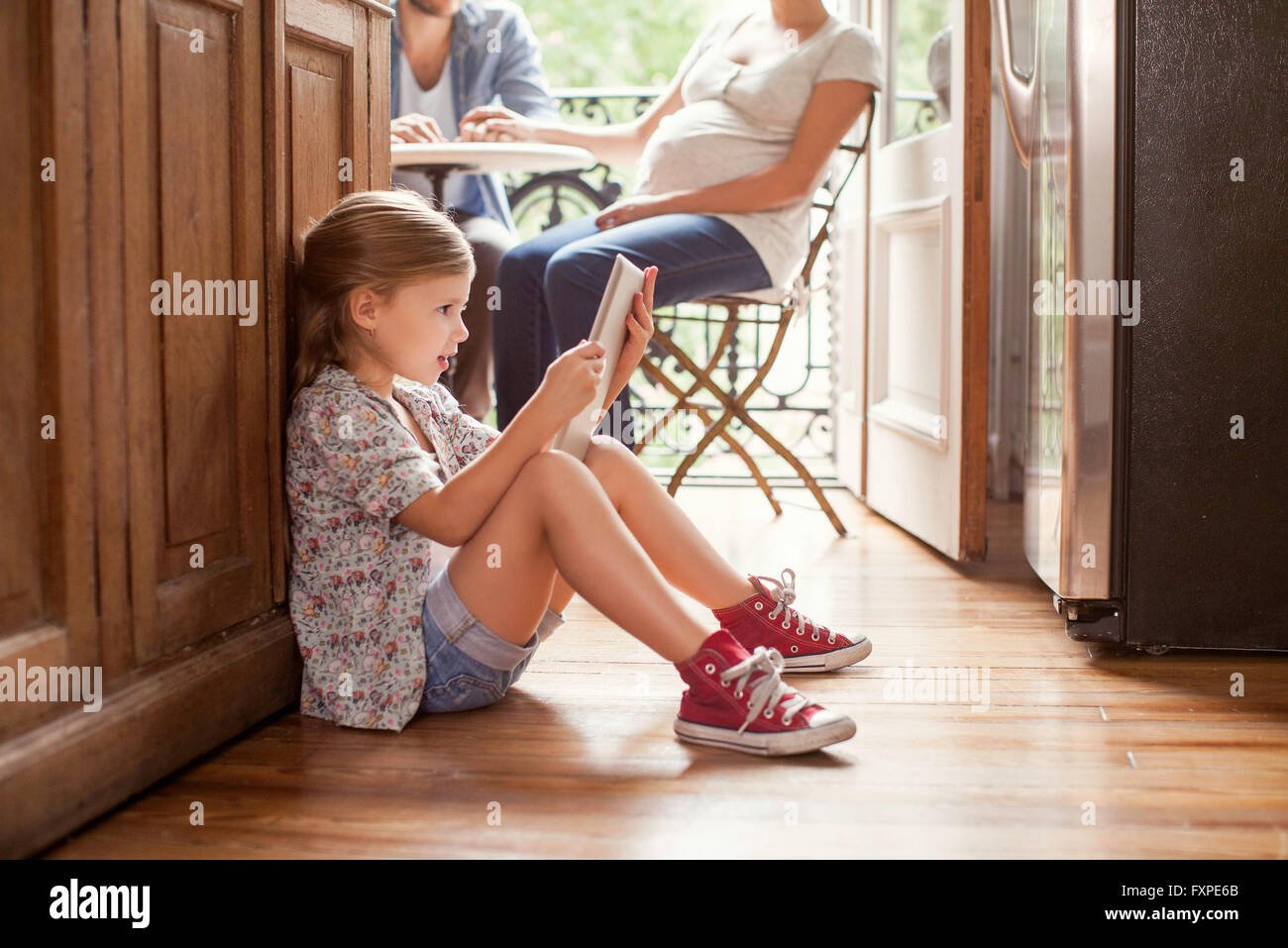 Girl engrossed in video streaming on digital tablet Stock Photo