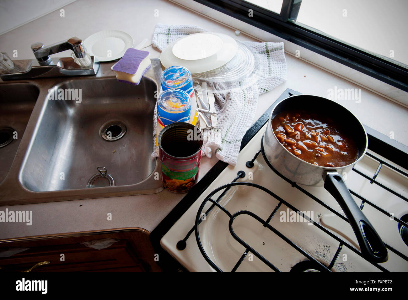 Canned soup cooking on stovetop in motor home Stock Photo Alamy