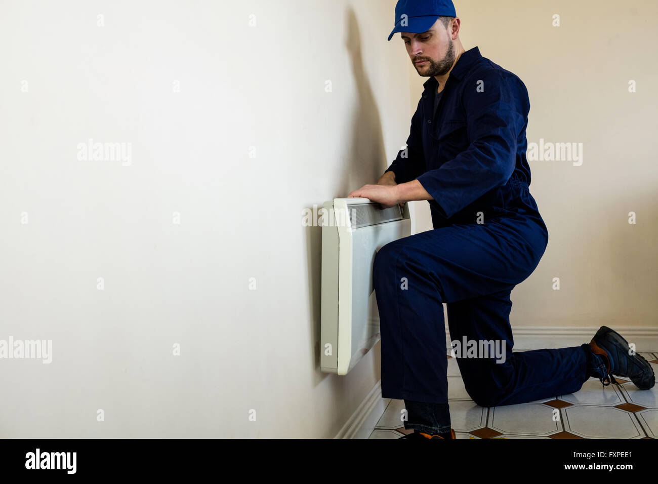 Handyman testing air conditioner Stock Photo Alamy