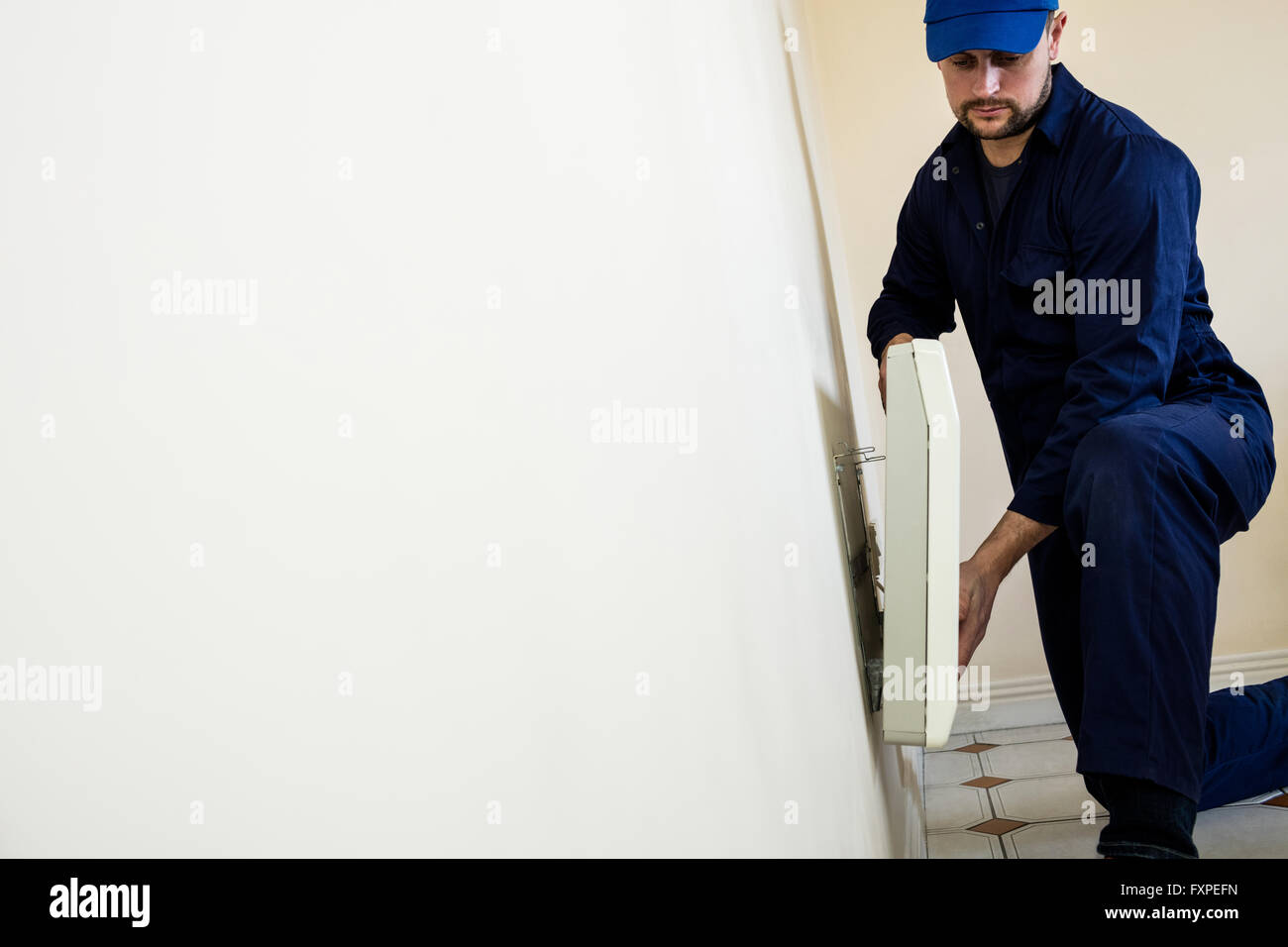 Handyman testing air conditioner Stock Photo Alamy