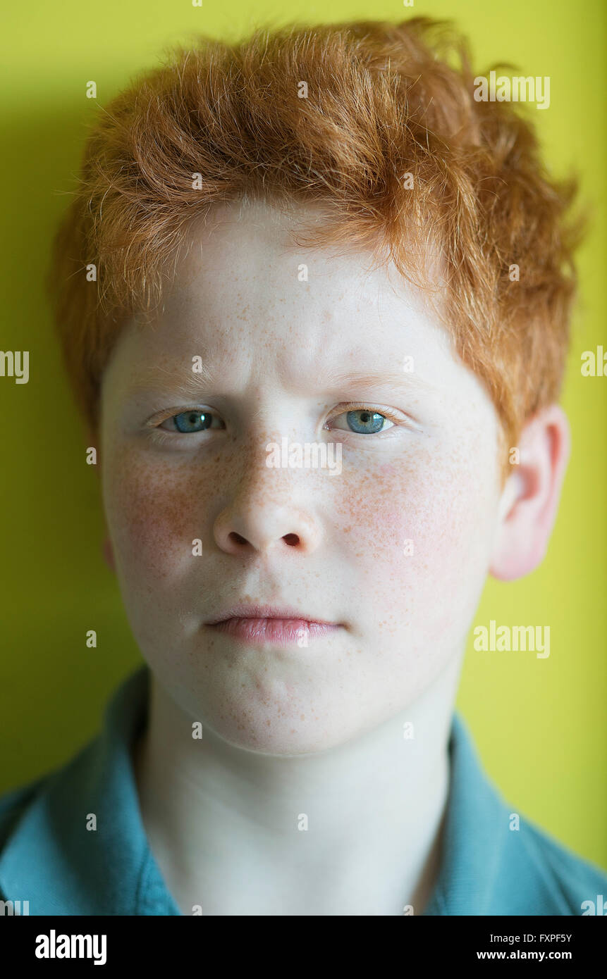 Boy with red hair furrowing brow, portrait Stock Photo