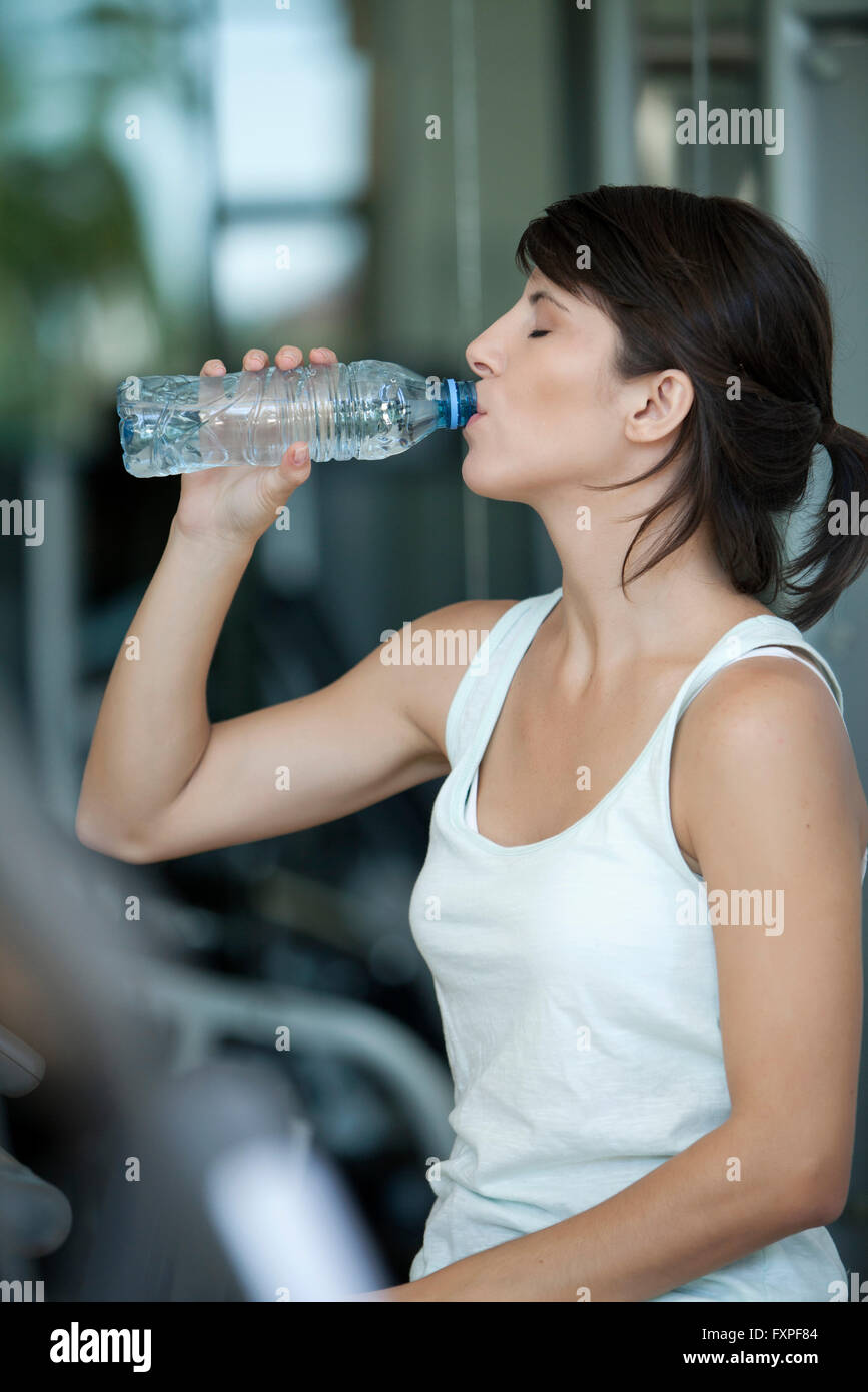 Woman drinking water after a workout Stock Photo Alamy