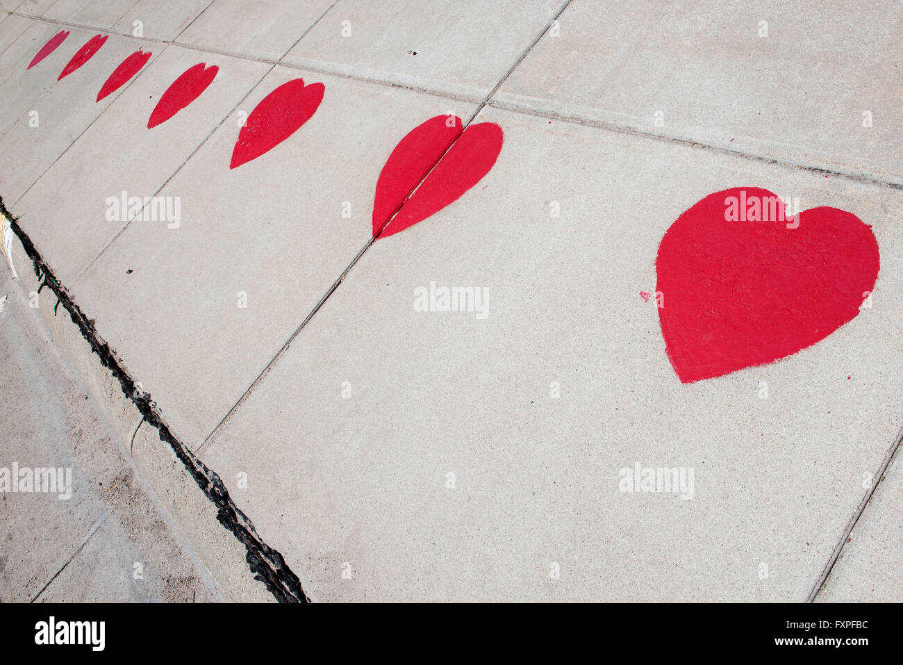 Hearts stenciled on sidewalk Stock Photo