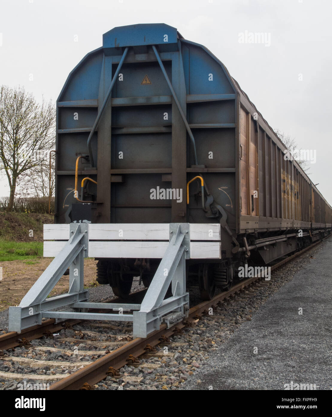 Covered goods wagons on sidings with buffer stop Stock Photo