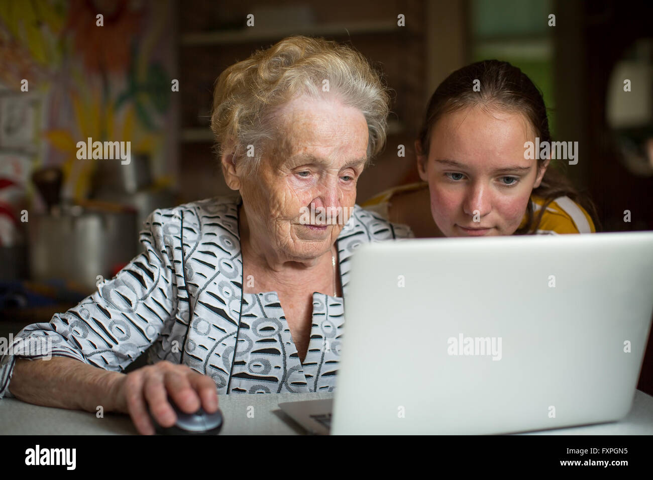 Grandmother and granddaughter learn to work on computer. Stock Photo