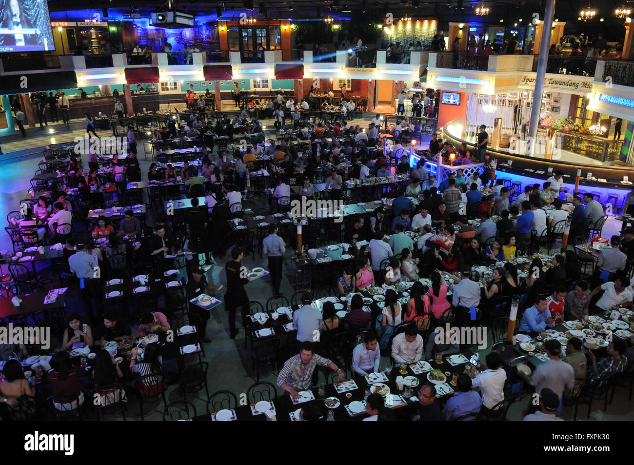 Dinner crowd at the grand opening of 'Spark & Tawandang German Microbrewery', Phnom Penh, Cambodia. credit: Kraig Lieb Stock Photo
